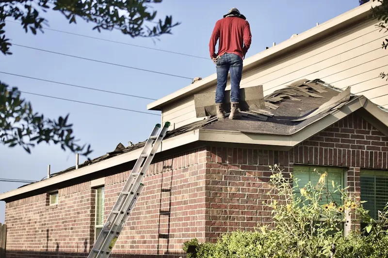 Professional roofer working on a residential roof in Plymouth